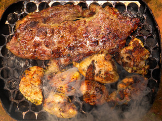 closeup barbecue beef and chicken on outdoor camping grill on vacation