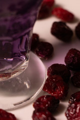 Purple gelatine in a moddy atmosphere, with warm and purply colours, surrounded by cramberries