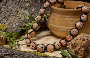Naklejka premium A runic circle, futark, made of natural clay lies between pieces of wood