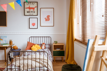 Single metal bed in fashionable bedroom interior for kid