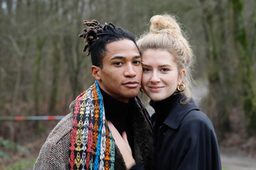 Young intercultural caucasian-hispanic student couple posing during a winter walk in Bottrop, Germany.