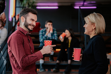 Charismatic young students while have a break time on the college drinking some coffee socializing with each other