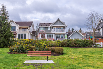 Bench in Park with residential background.
