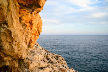 horizon view of the sea with rocks in the foreground in Sicily