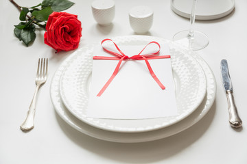 Valentine's day or birthday dinner. Elegance table setting with red decor.