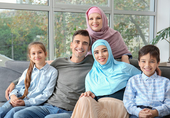 Portrait of happy Muslim family at home