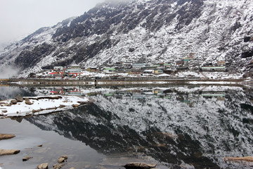 Reflection of snowy mountain over  Tsomgo Changu Lake sacred natural glacier lake on top of mountain in Gangtok,East Sikkim, India