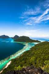 Fototapeta premium Amazing tropical paradise islands from air with blue turquoise blue lagoon water and coral reef. Aerial view of Bohey Dulang island panorama. Hawaii, Philippines, French polynesia.