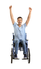 Happy young man in wheelchair on white background