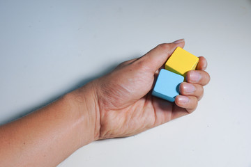 wood toys in hand isolated on white background