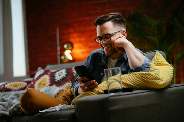 Obraz premium Young man having a video call. Handsome man talking on his smartphone.
