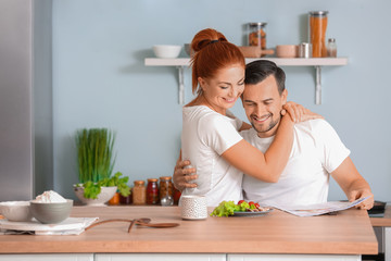 Happy couple in kitchen at home