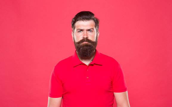 Fashion Portrait Of Man. Male Beauty And Fashion. Job Of Cashier. Being Trendy And Brutal. Facial Beard Care. Bearded Man Casual Style. Professional Barber Red Background. Mature Hipster Serious Look