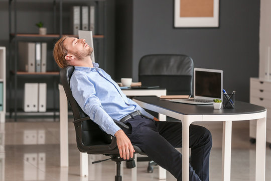 Handsome Businessman Sleeping In Office