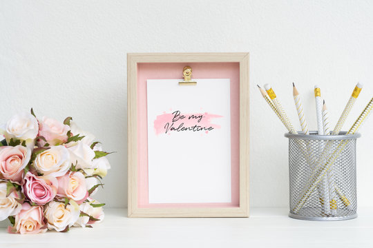 Mockup Picture frame and pink roses. Valentines Day Background concept with copy space. Mock up with photo frame and flowers with space for your picture or text