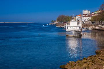 Old ship at Douro River mouth in a beautiful early spring day at Porto City in Portugal