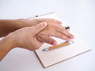 Thai Asian people with symptom sore hand and wrists pain from work. Hand with cramp and finger trigger.