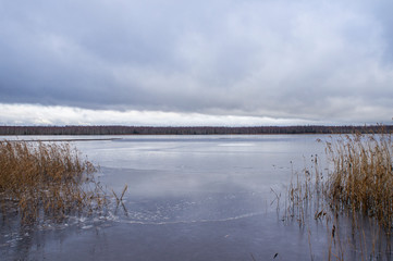 Ice lake at sunset in winter. Frozen shore