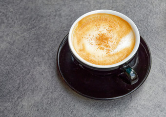 italian style cappuccino coffe black cup on grey granite background