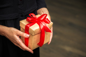 Close up view of old woman holding a gift box