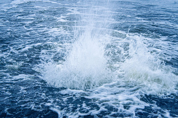 Water boils near the shore in winter. Storm fountain
