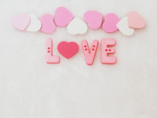 Valentines day background, word love and heart on white wool background