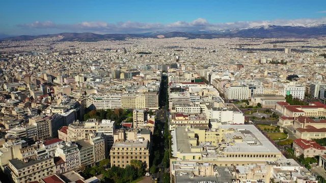 Aerial drone video of Athens urban cityscape featuring famous landmark trilogy neoclassic buildings - Academy of Athens, University and National Library, Attica, Greece