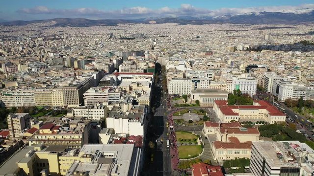 Aerial drone video of Athens urban cityscape featuring famous landmark trilogy neoclassic buildings - Academy of Athens, University and National Library, Attica, Greece