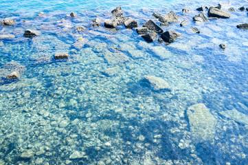 Clear water of mediterranean sea, along the seashores of Ortigia, Sicily (Southern Italy), summertime.