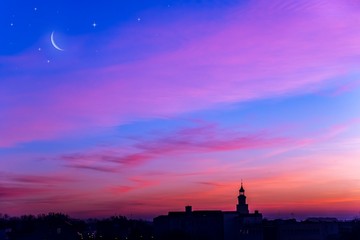tower silhouette . New moon .  The sky at night with stars . Sunset above the city