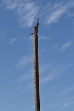 Old Abandoned Bare Broken Telephone Electric Pole With Guy Wire Ready For Sign Signage 