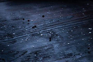 black wooden table with salt and pepper like background