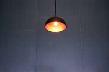 Vintage ceiling lamp and blurred gray wall dark background                       