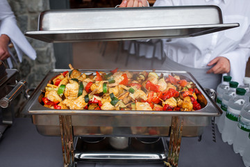  fried chicken kebabs with vegetables in a food warmer