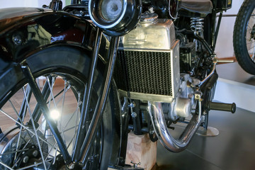 Fototapeta premium The detail of the old motorcycle with part of the frame, engine, fuel tank, fuel lead and cooler. 