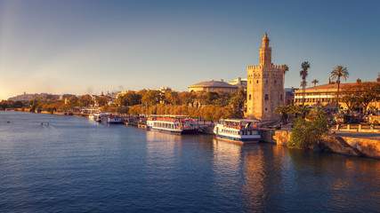 Fototapeta premium Torre del Oro (Tower of Gold), with sunset lights, on the Guadalquivir riverbed, Seville, Spain