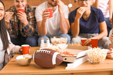 Group of fans watching rugby on TV