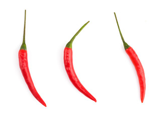 Three red chili pepper pods on white isolated background. Indian cuisine, ayurveda, naturopathy concept