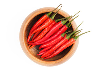 Red chili pods in wooden bowl isolated on white background. Indian cuisine, ayurveda, naturopathy concept
