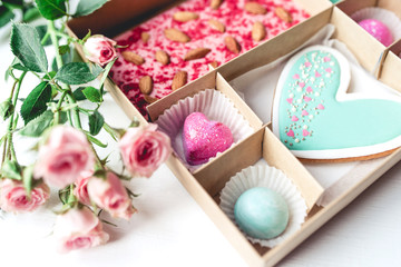 Gift set with hand made sweets in a box on a white table. Flat lay, top view.