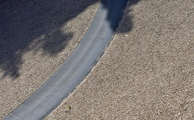 Road between gravel in a swamp dam seen from above