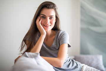 Beauty young woman with white perfect smile looking at camera at home