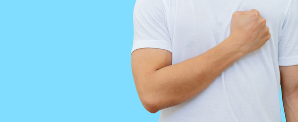 close up young man fist on chest to showing strength and fighting with heart attack disease and cancer survivor concept