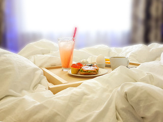 Healthy breakfast in bed for a girl in a cozy bedroom.