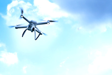 Fototapeta na wymiar Close up Drone flying a cloudy sky.