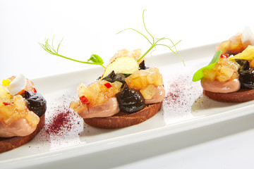 Duck Pate on Toasted Bread with Truffle Oil and Prune Cream Isolated
