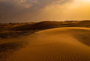 Fototapeta na wymiar rain is approachingin the desert, faraway on the horizon 
