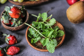 Photo of fresh mint leaves in a bowl. Mint and strawberry. Ingredients for summer cocktails and lemonade. Herb. Still life photography. Image