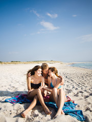 Fototapeta premium Three girls having fun on the beach