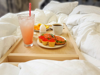 Healthy breakfast in bed for a girl in a cozy bedroom.